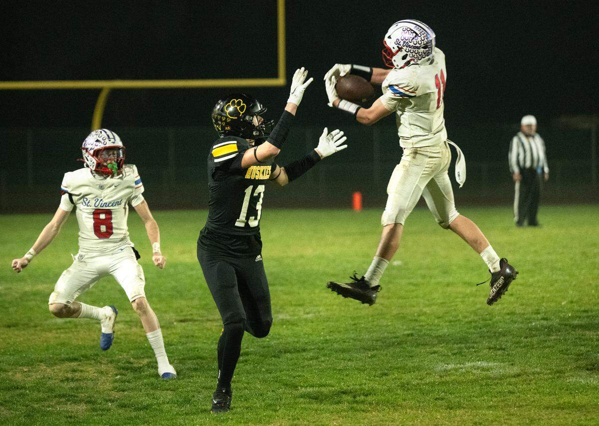 St. Vincent’s Tyler Chelew intercepts a pass intended for Hughson’s Bryce Mcdaniel during the CIF Northern California Division 4-AA Bowl Game in Hughson, Friday, Dec. 6, 2024.