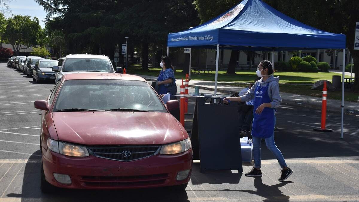 Students pick up food boxes from the Pirates Pantry Relief Project at the Modesto Junior College East Campus on Thursday, April 23, 2020.