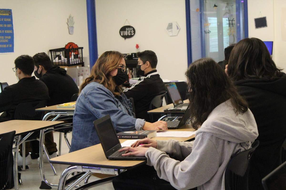 Teacher Melissa Medina works with students in a 10th grade English class at Aspire Vanguard College Preparatory Academy in Modesto on Nov. 19. While Medina monitored the larger group of students, an education specialist gave a few students extra support.