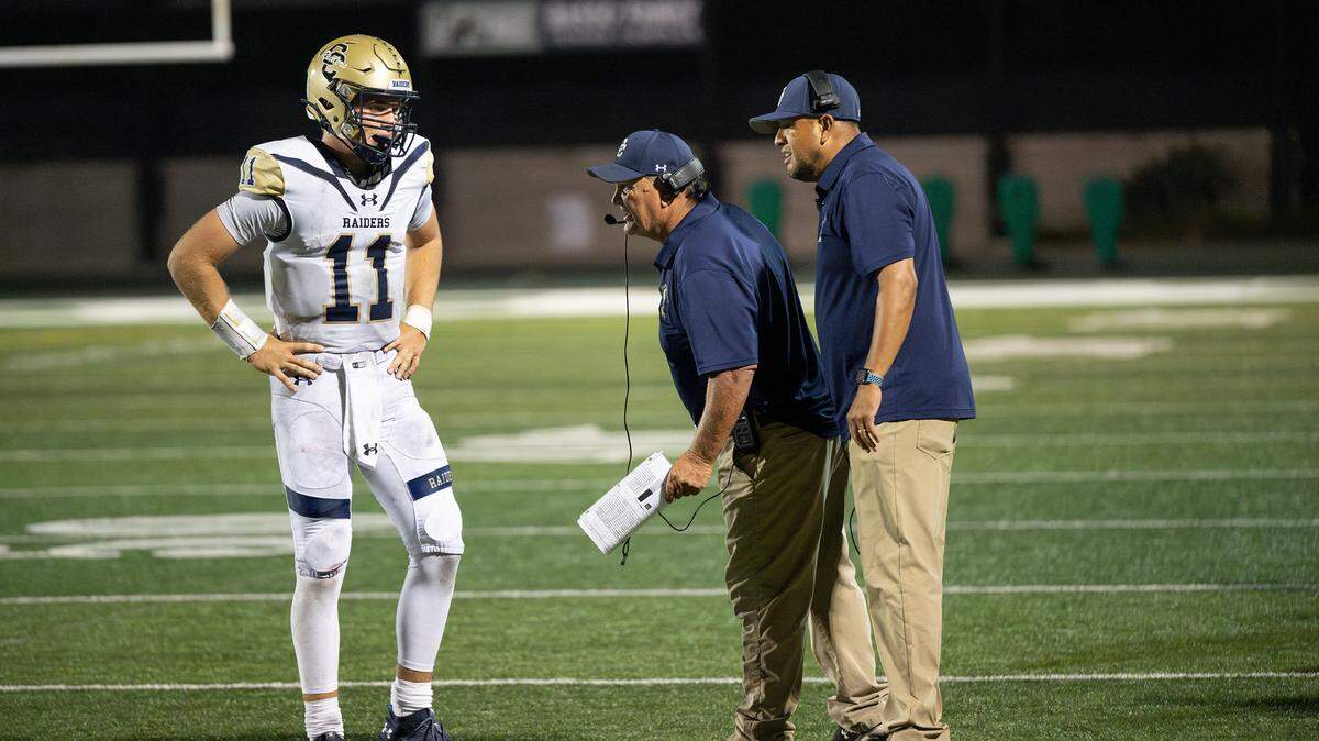 Central Catholic coaches Roger Canepa, middle, and Tim Garcia talk with quarterback Tyler Wentworth during the game with St. Mary’s in Stockton, Calif., Friday, August 25, 2023. St. Mary’s won the game 42-33.