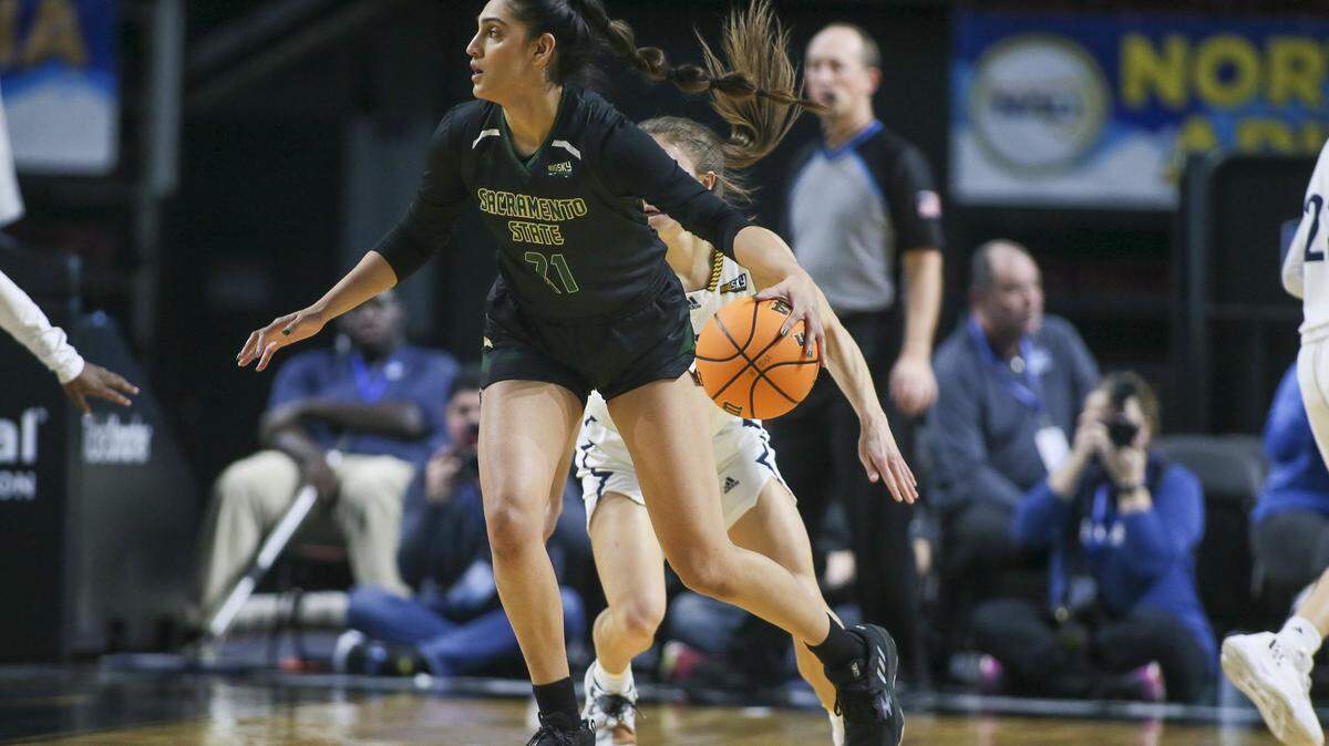 Mar 8, 2023; Boise, ID, USA; Sacramento State Hornets guard Kaylin Randhawa (21) dribbles against Northern Arizona Lumberjacks guard Regan Schenck (1) during the first half at Idaho Central Arena. Mandatory Credit: Brian Losness-USA TODAY Sports