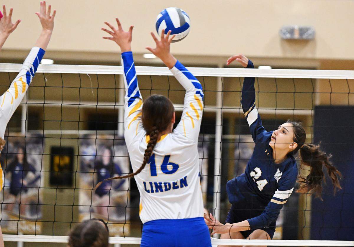 Central Catholic’s Izabelle Alkhas spikes the ball during the first round D3 playoff game with Linden at Central Catholic High School in Modesto, Calif., Tuesday, Oct. 24, 2023.