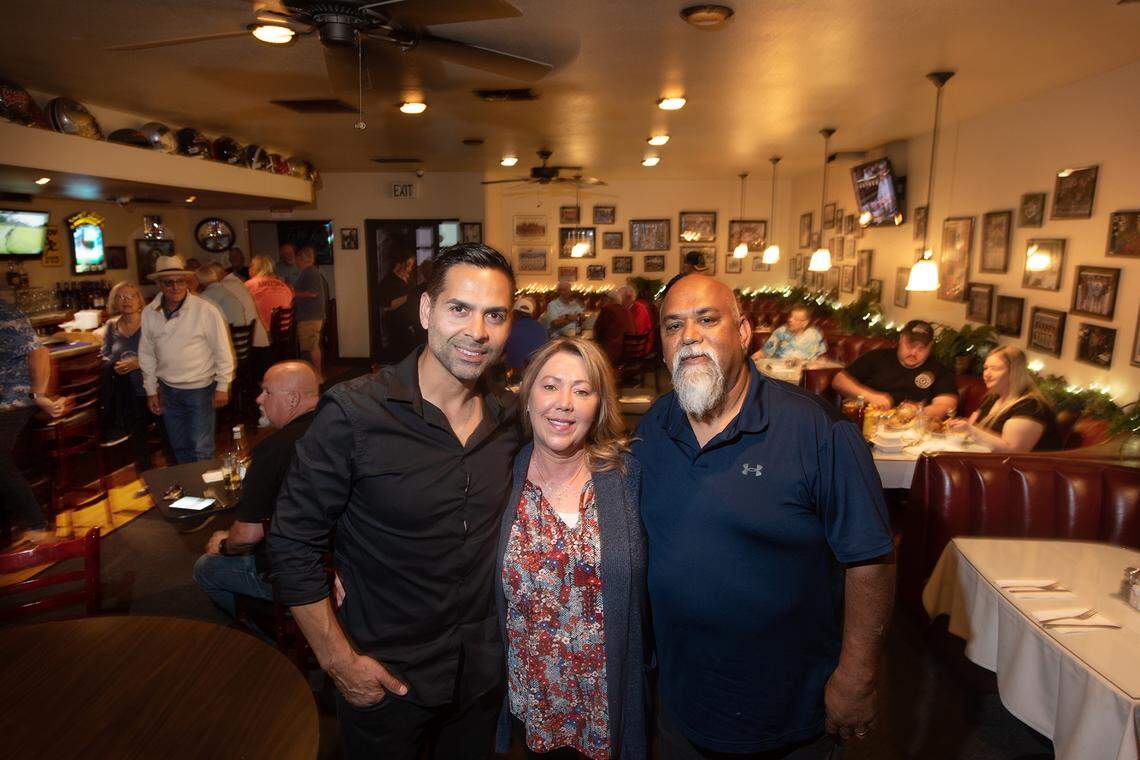 Krystal Harakh, middle, and Shiulal “Chubs” Harakh, right, sold Coach’s Corner in Modesto, Calif., on Friday, April 29, 2022. Nelson Ramirez, left, took over operating the restaurant and bar under the name The Standard Pub.