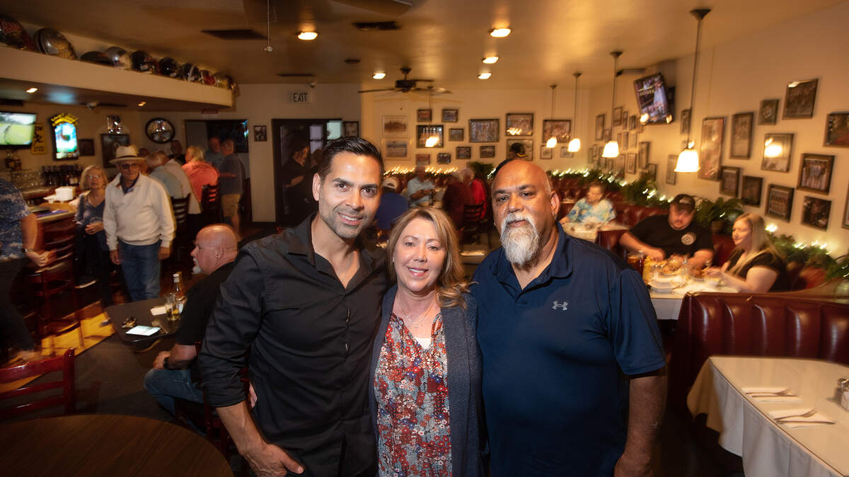 Married owners Krystal, middle, and Shiulal “Chubs” Harakh, right, will step down from operating the Coach’s Corner in Modesto, Calif., on Friday, April 29, 2022. Nelson Ramirez, left, will take over operating the restaurant and bar under the name The Standard.