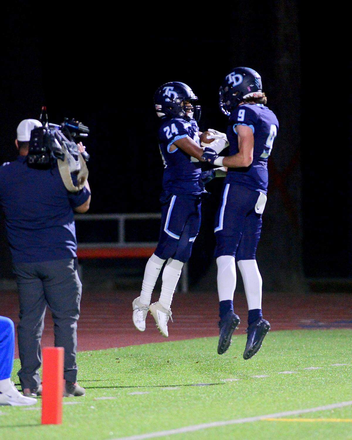 Downey running back Marcus Cruz (24) celebrates with Daley Homes (9) after scoring a touchdown during a game between Downey and Gregori at Downey High School in Modesto, California on October 27, 2023.