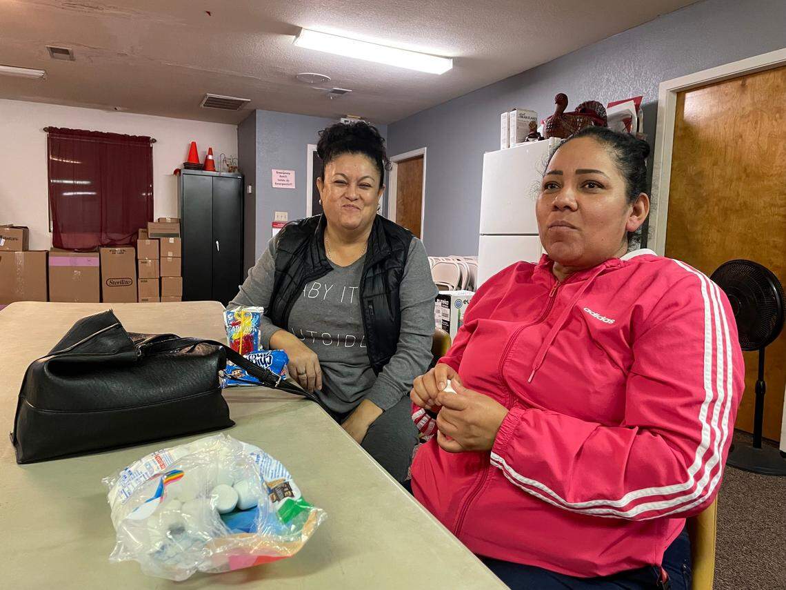 Rosa Garcia, right, and Raquel Hernandez, left, sit aside as their daughters and friends play during a regular Girl Scout meeting. Both Garcia and Hernandez prefer to speak Spanish.