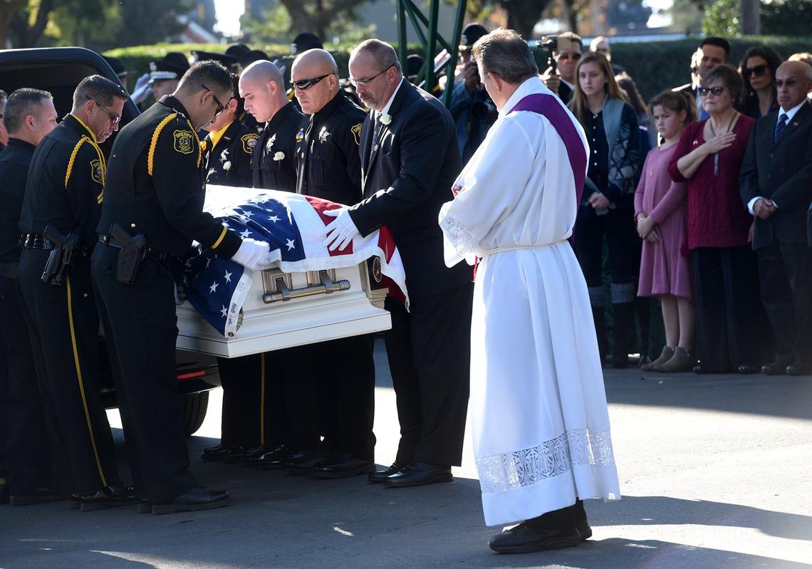 Pallbearers take the casket from the hearse at the burial service for Stanislaus County Sheriff’s deputy Antonio “Tony” Hinostroza at Lakewood Memorial Park in Hughson, Calif. Thursday December 6, 2018.