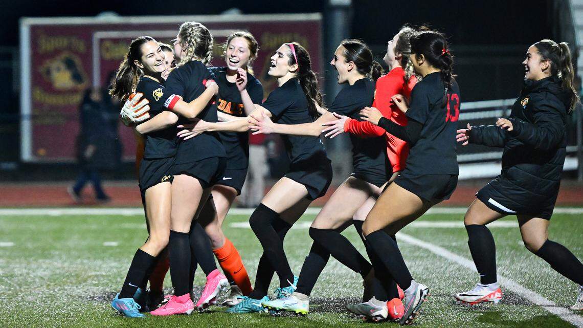Oakdale players mob Mia Peterson, left, as they celebrate their victory over Manteca in the Sac-Joaquin Section Division III semifinal game with Manteca in Oakdale, Calif., Friday, Feb. 16, 2024.