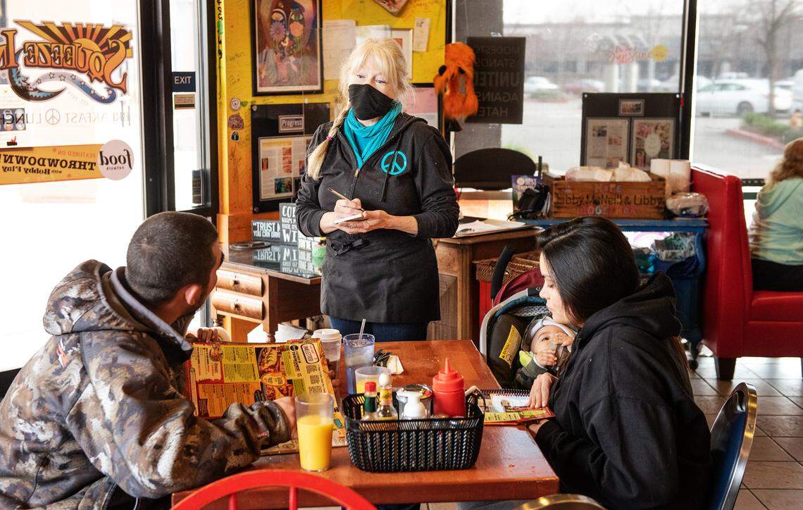 Owner Kathy Monday takes the lunch order from the Mendez family at the Squeeze In restaurant in Modesto, Calif., on Thursday, Jan. 13, 2022.