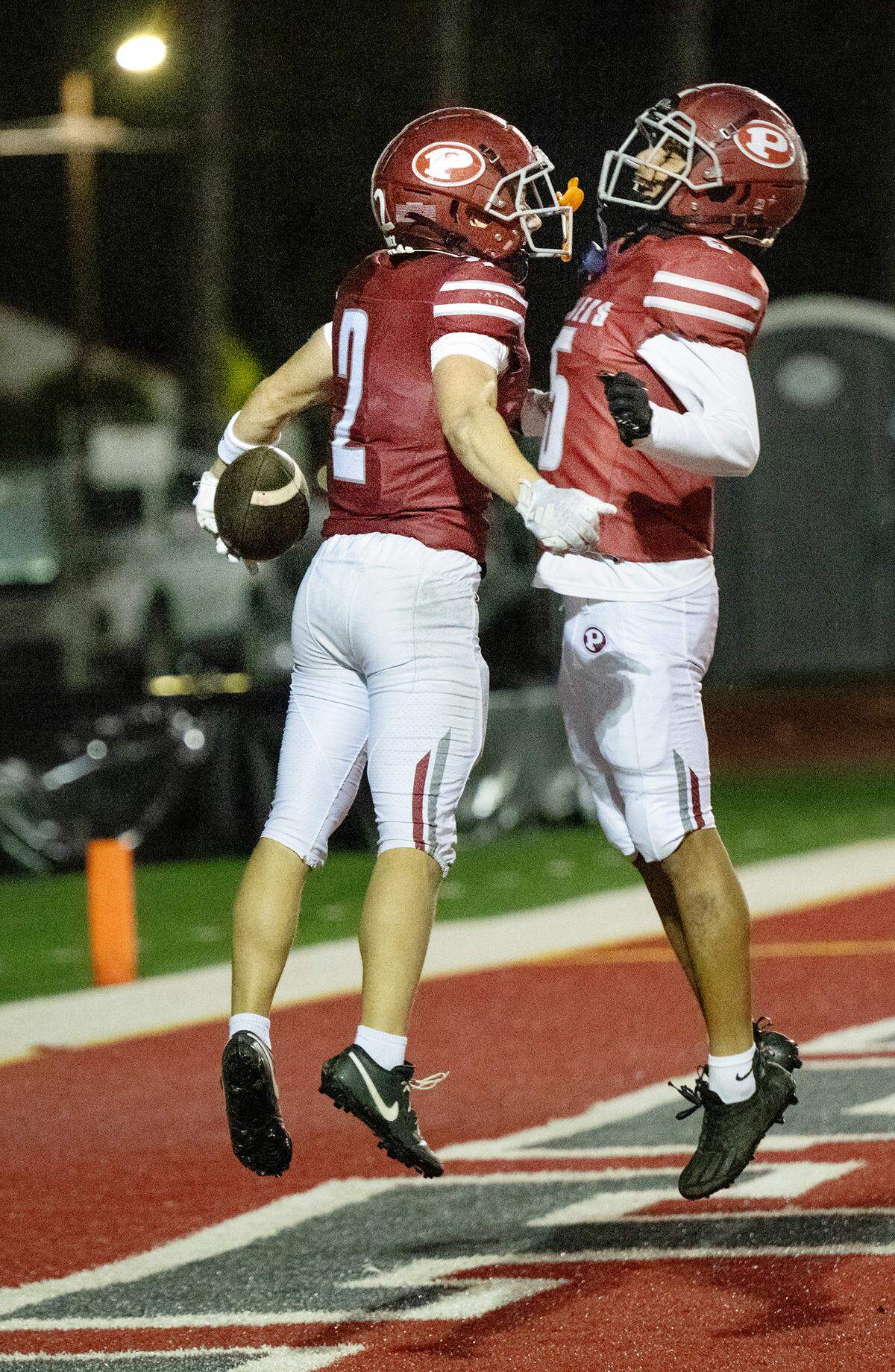 Patterson’s Noah Cozart (2) and Xavier Tinoco celebrate a touchdown in the Sac-Joaquin Section Division IV semifinal game with Sacramento at Patterson High School in Patterson, Friday, Nov. 22, 2024.