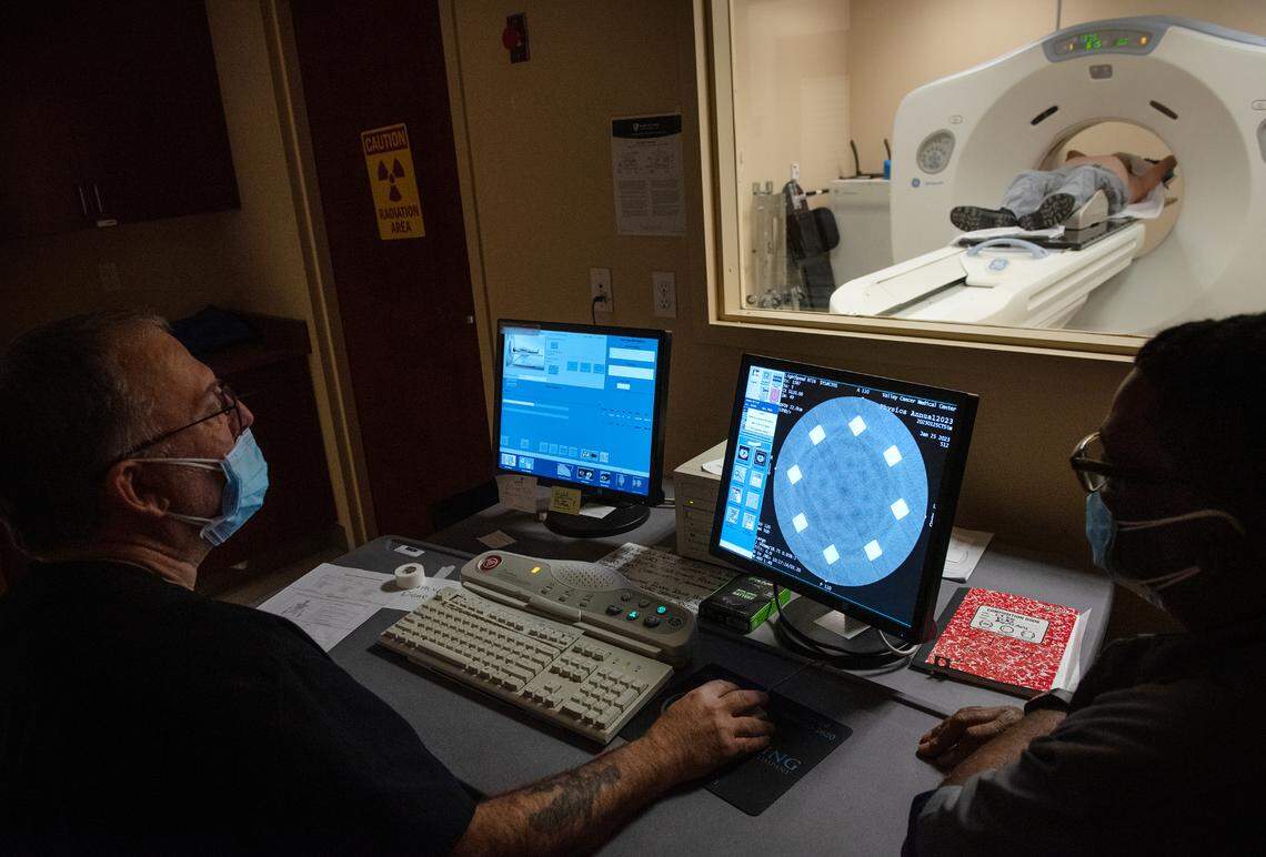 Radiation technicians Bat Jones (cq), left, and Robert Carroll, right, scan a patient using computerized tomography (CT) at the Valley Cancer Medical Center in Manteca, Calif., Wednesday, Jan. 23, 2023.