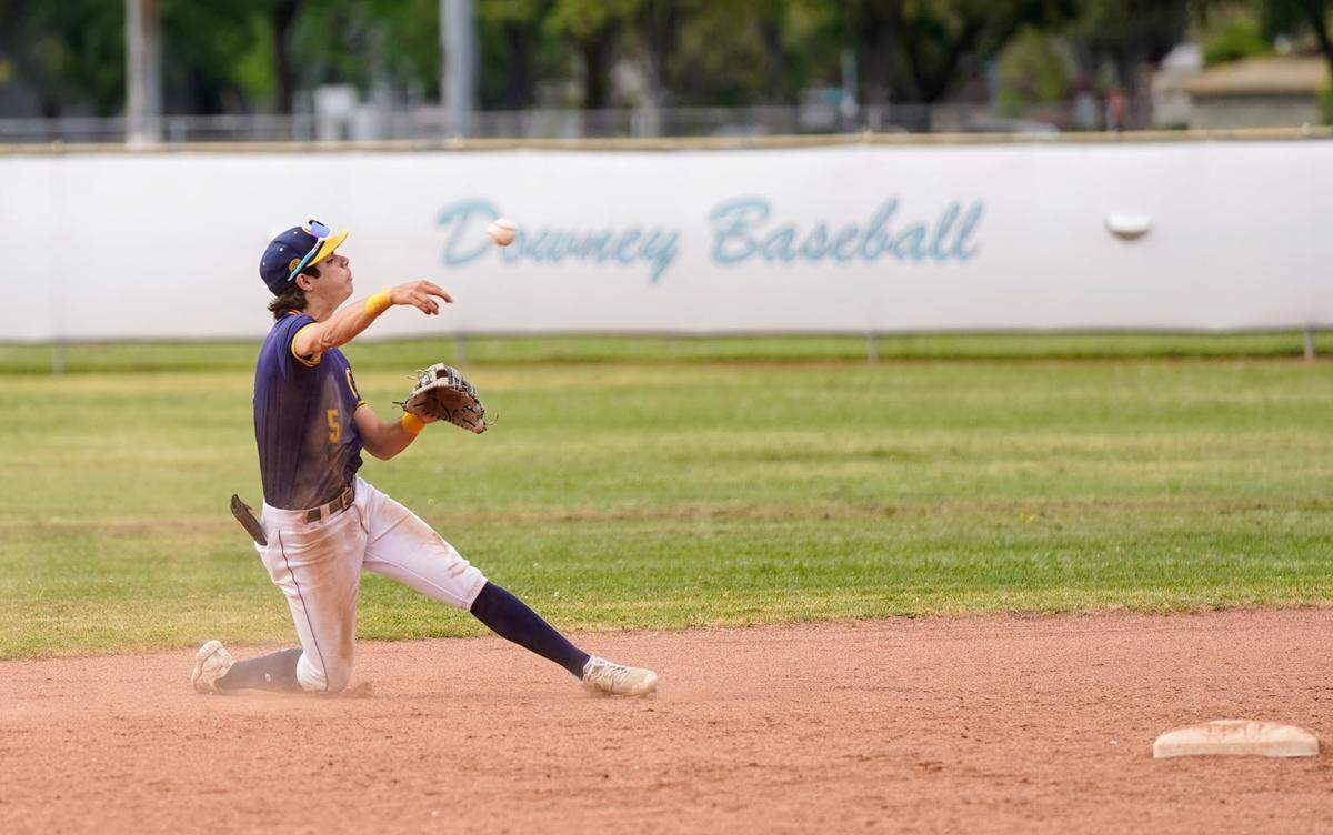 Gregori second baseman Stefan Thoukis throws to first after making a diving catch in a CCAL game against Downey High at Downey High School in Modesto, Calif. on Wednesday, April 16, 2025.