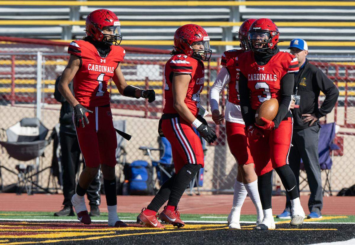 Woodland Christian players celebrate a Noah Hinkle touchdown (3), right, during the Sac-Joaquin Section Division VII NorCal Qualifier with Ripon Christian at Sacramento City College in Sacramento, Calif., Saturday, Nov. 25, 2023.