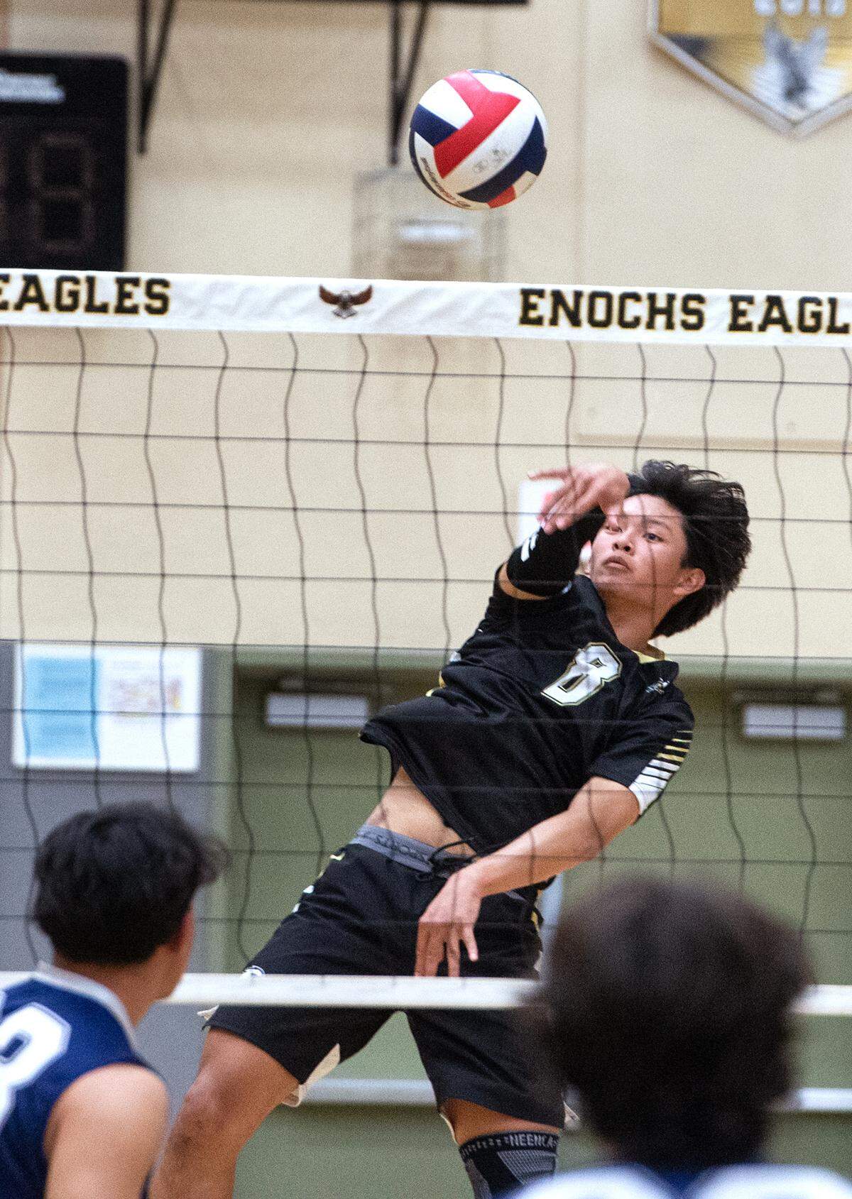 Enochs’ Matthew Suico spikes the ball during the Central California Athletic League match with Downey at Enochs High School in Modesto, Calif., Tuesday, April 4, 2023. Enochs won the match 3-1.