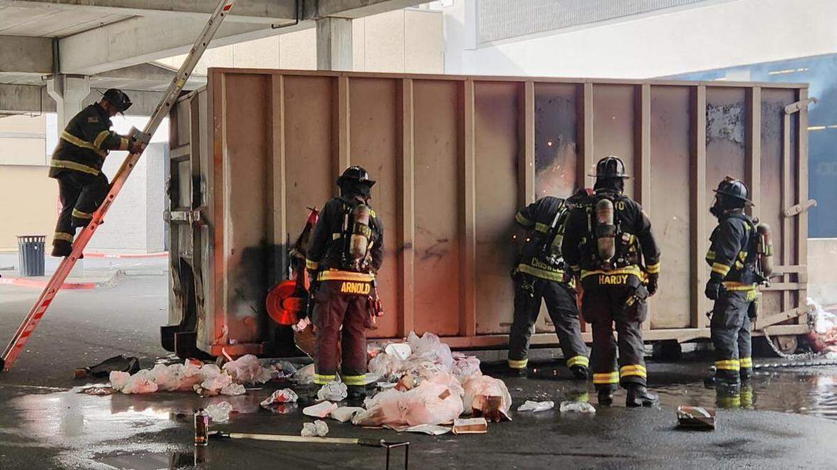 Firefighters do mop-up on a fire in the trash compactor at the Macy’s Women’s store at Vintage Faire Mall in Modesto on Monday, Feb. 3, 2025.