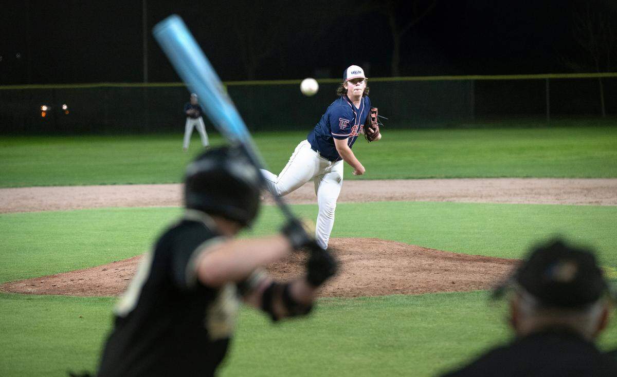 Turlock Christian’s Winston York delivers a pitch during a game with Millennium of Tracy under new LED lights at Pedretti Park in Turlock, Calif., Thursday, March 28, 2024.