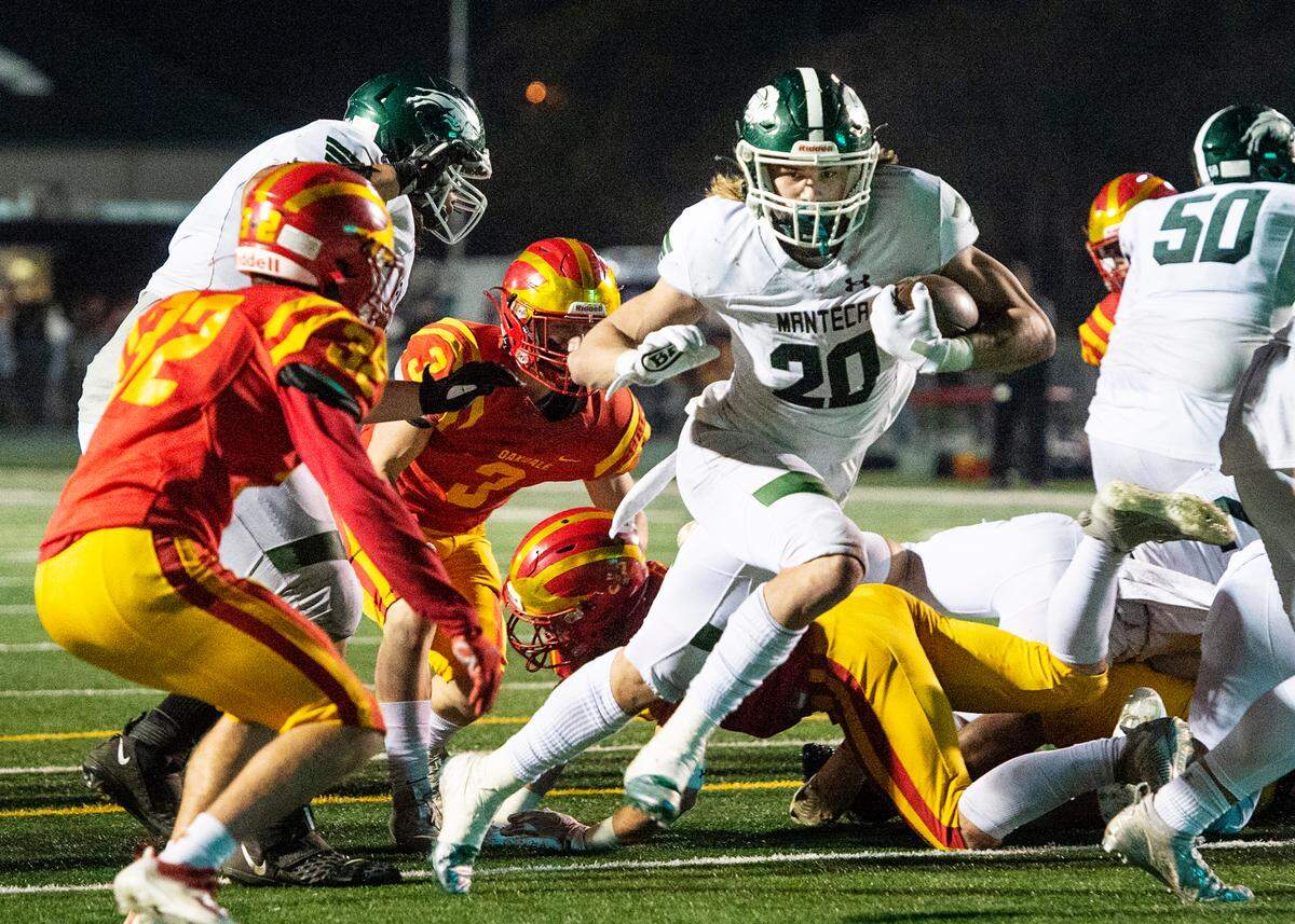 Manteca’s Blake Nichelson runs for a touchdown during the Sac-Joaquin Section Division III championship game with Oakdale at St. Mary’s High School in Stockton, Calif., on Friday, Nov. 25, 2021. Manteca won the game 35-28.