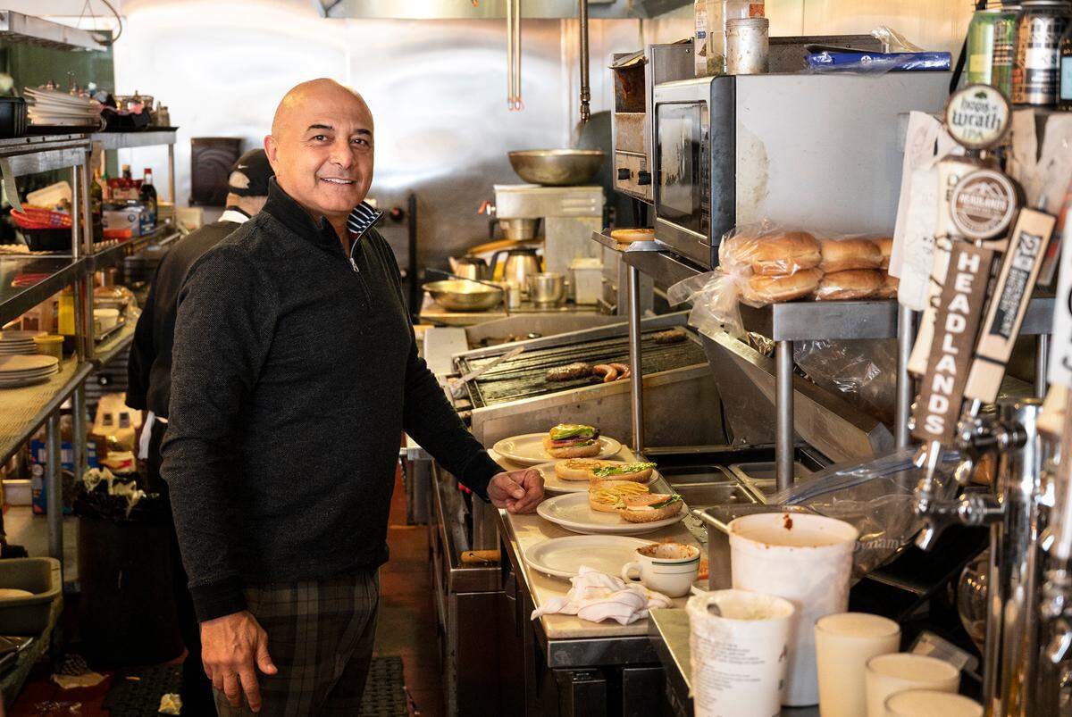 Owner Hanibal Yadegar pauses during a lunch rush at Barkin’ Dog Grill in Modesto, Calif., on Thursday, Dec. 16, 2021.