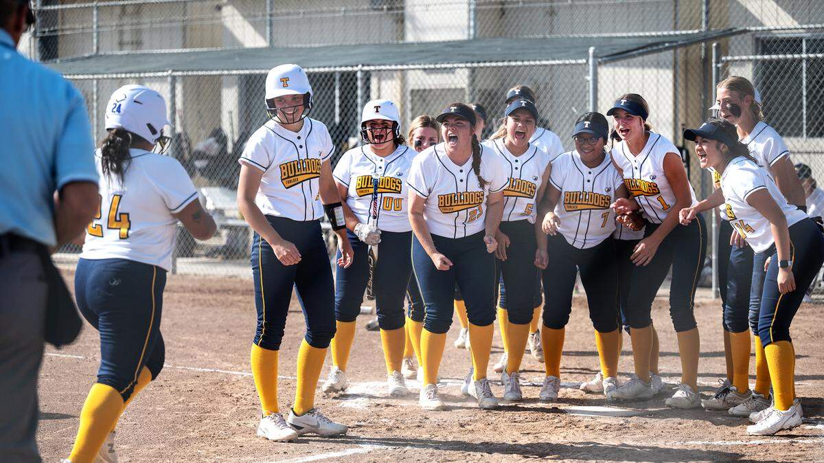 Turlock players celebrate the home run by Angie Valenzuela (24) during the Central California Athletic League game with Pitman at Turlock High School in Turlock, Calif., on Thursday, April 7, 2022. Turlock won the game 8-2.