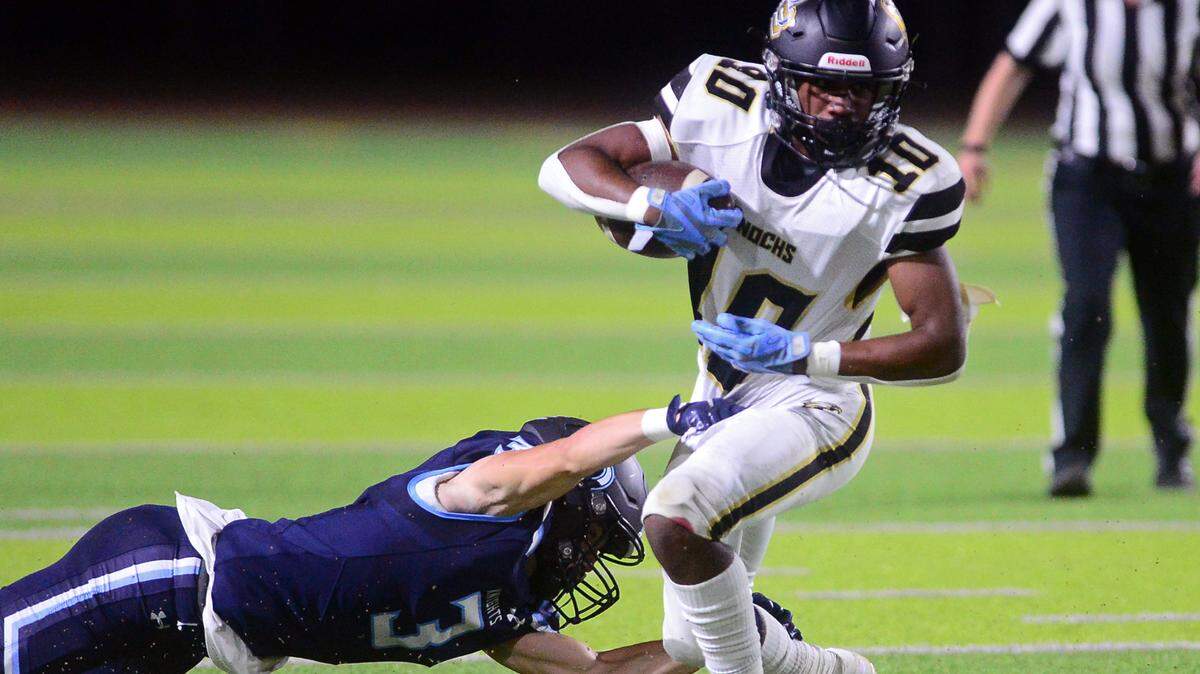 Enochs running back Aiden Muhammad tries to escape an arm tackle during a game between Downey High School and Enochs High School at Downey High School in Modesto CA on October 13, 2022.