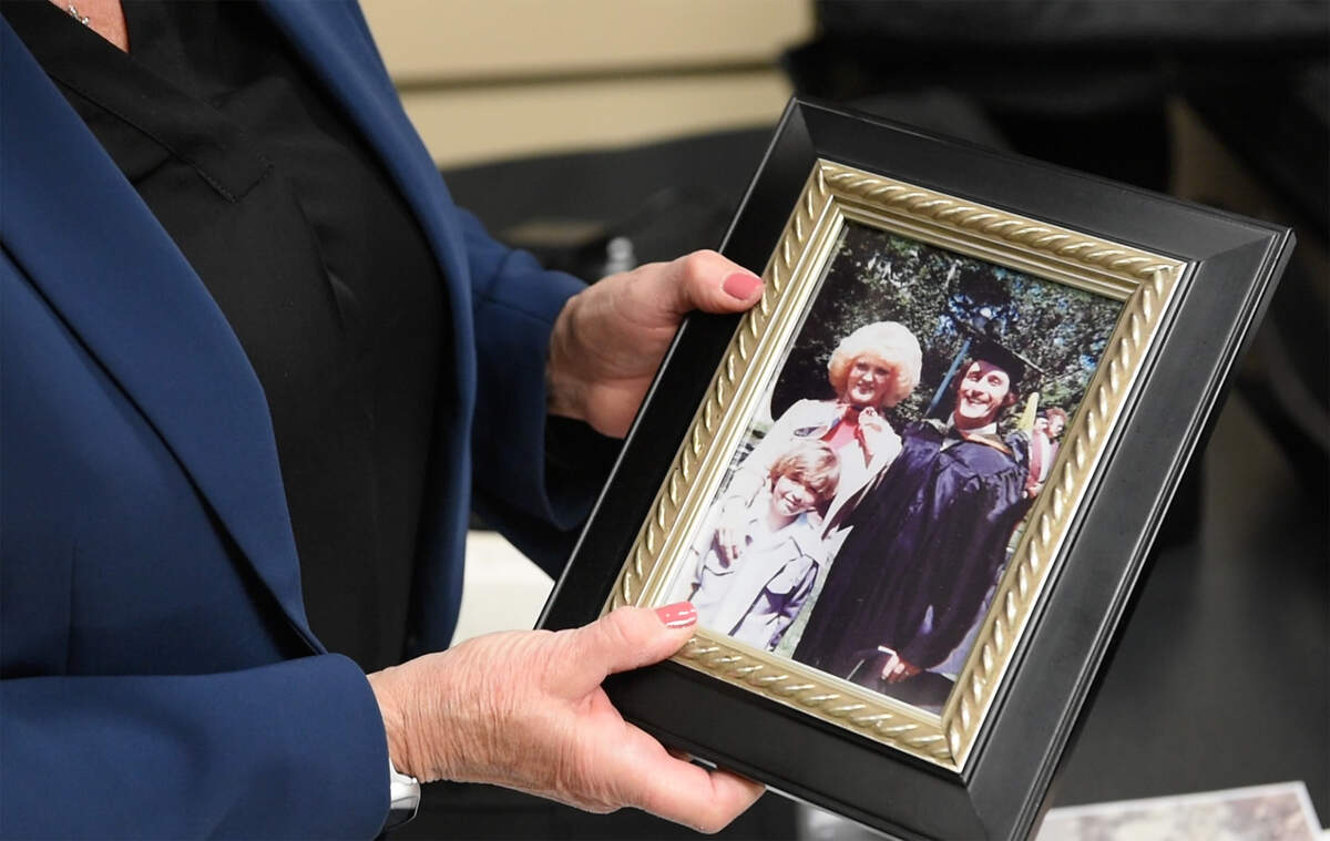 Sandy Ranzo-Howell shows a picture of her brother, Phillip Ranzo, the day he graduated from pharmacology school at the University of the Pacific in 1976. He is pictured with his wife, Kathy, and son, Mark. In 1979 when Mark was 10 years old, his parents were murdered in their Modesto home.