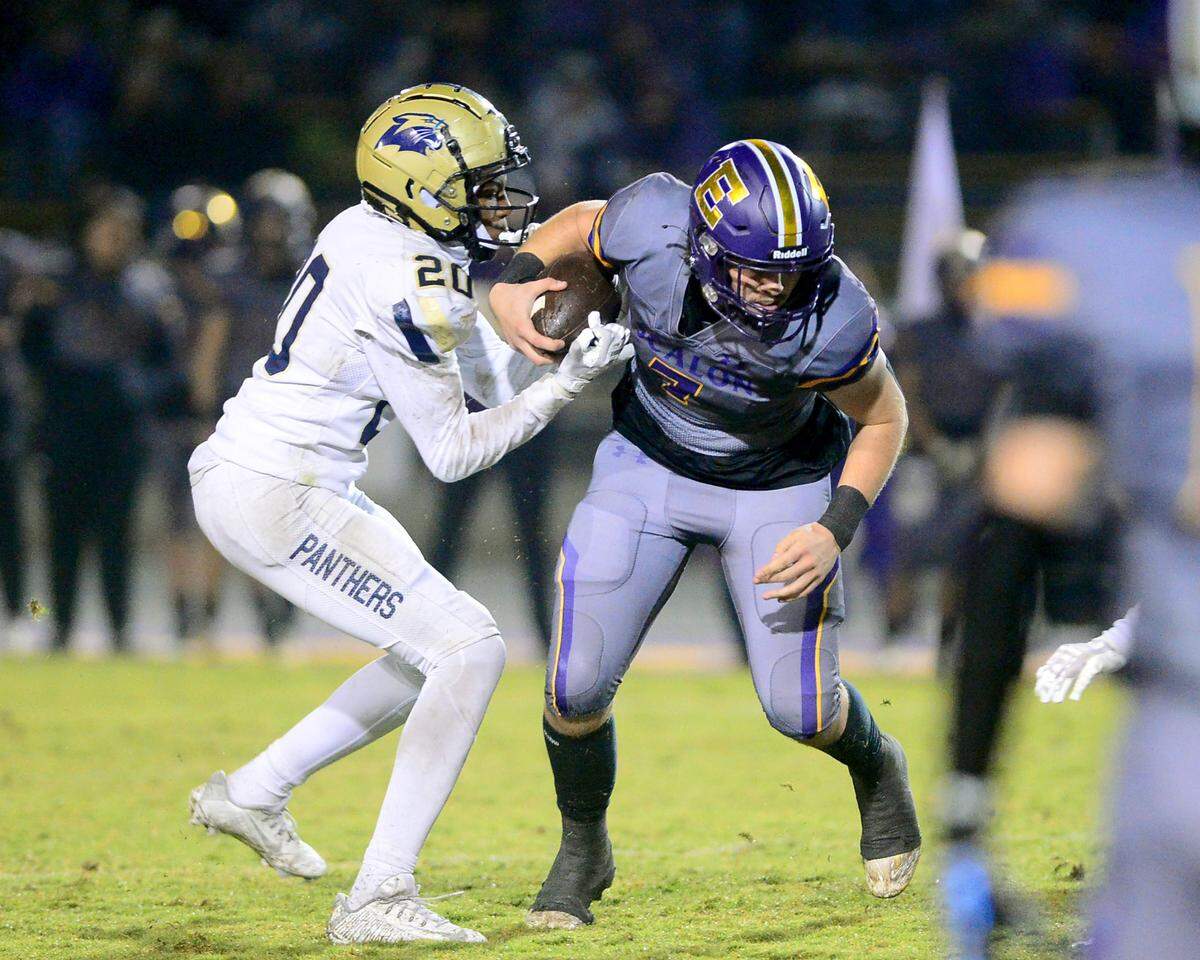 West Park defender Jonah Cruz (21) fights for the ball with Escalon quarterback Donovan Rozevink (7) during a 2023 CIF San Joaquin Section Division IV football game between Escalon and West Park at Escalon High School in Escalon, California, on Nov. 17, 2023. Escalon won the game 48-28.