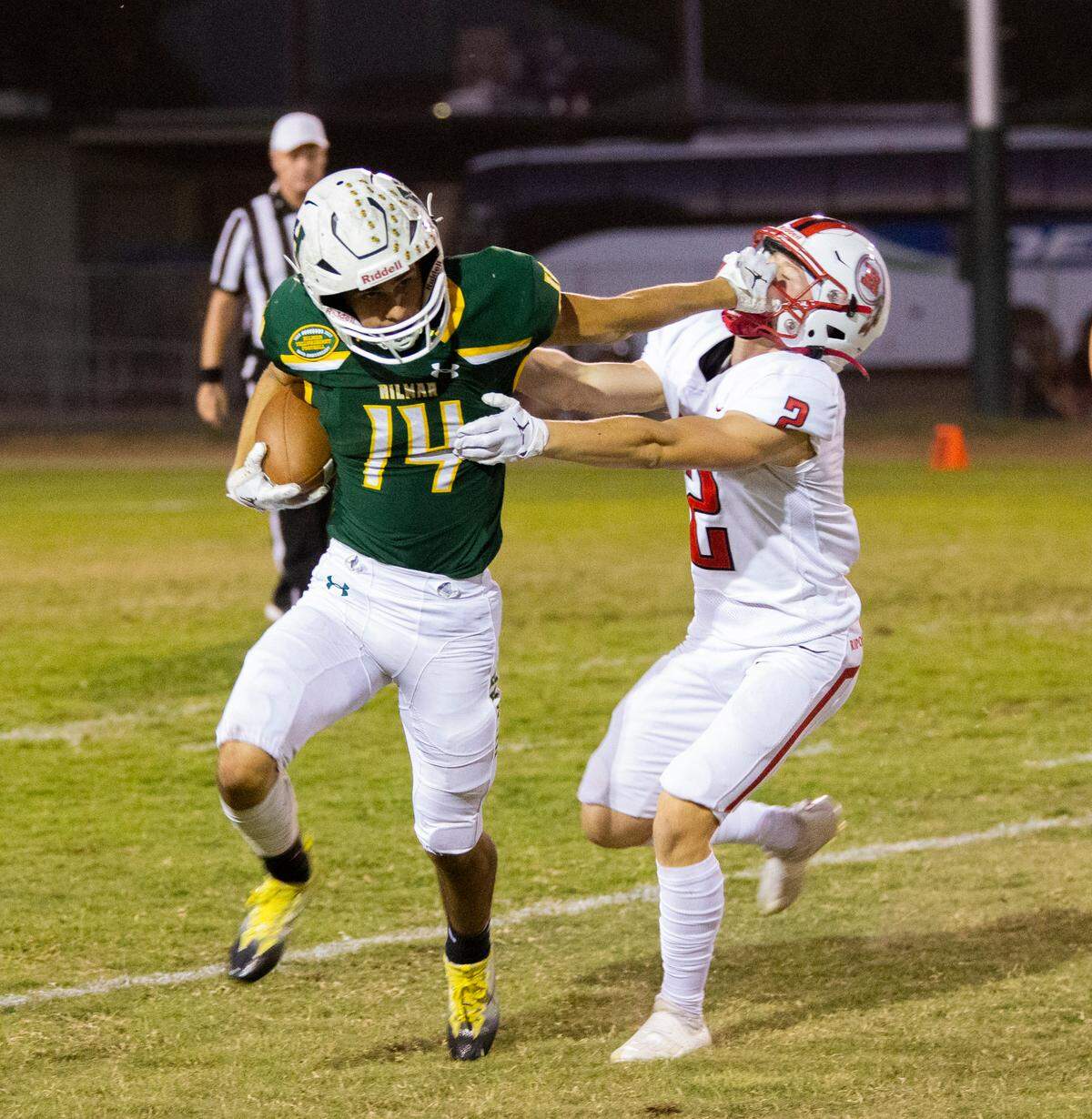 Luis Vargas, 14, of Hilmar pushes away Trent Vink, 2 of Ripon away as he works his way upfield. Ripon vs Hilmar at Hilmar Sept. 23, 2022.