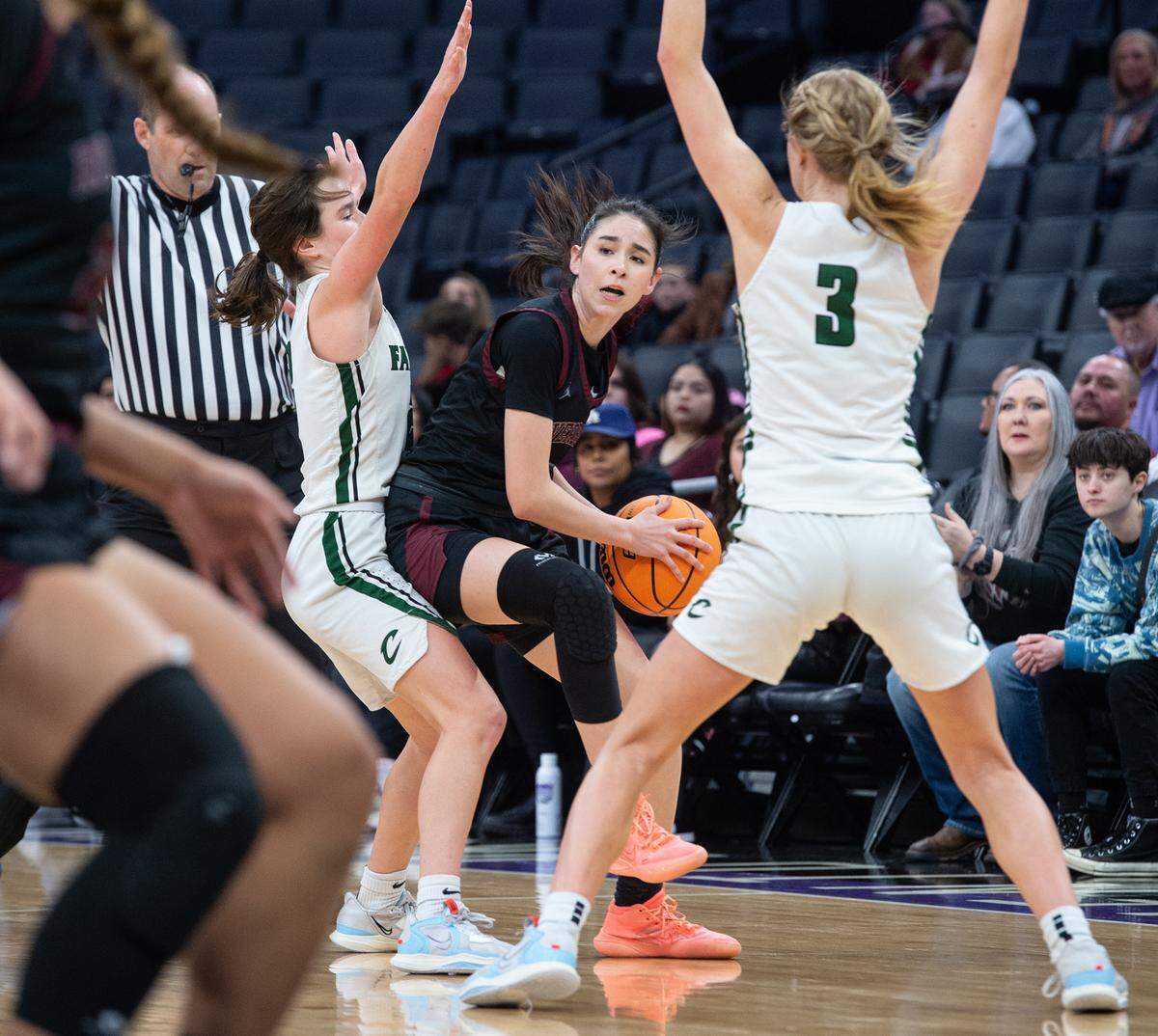 Riverbank’s Livi Fernandez looks to pass under pressure from Colfax defenders Maycee Heimann (3) and Jade Biittner during the Sac-Joaquin Section Division IV championship game at Golden 1 Center in Sacramento, Calif., Friday, Feb. 24, 2023. Colfax won the game 56-38.