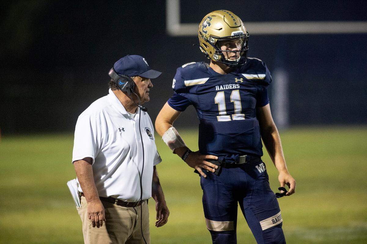 Central Catholic coach Roger Canepa talks with quarterback Tyler Wentworth during the second round Sac-Joaquin Section football playoff game with Lodi in Modesto ,Calif., on Friday, Nov. 12, 2021.