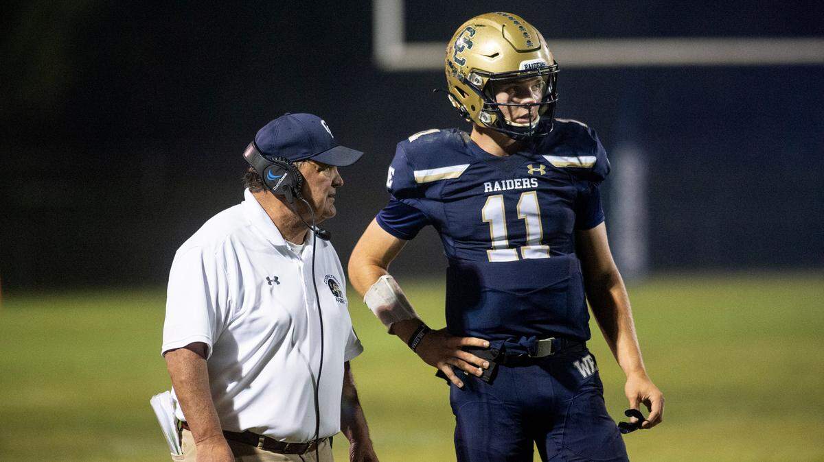 Central Catholic coach Roger Canepa talks with quarterback Tyler Wentworth during the second round Sac-Joaquin Section football playoff game with Lodi in Modesto ,Calif., on Friday, Nov. 12, 2021.