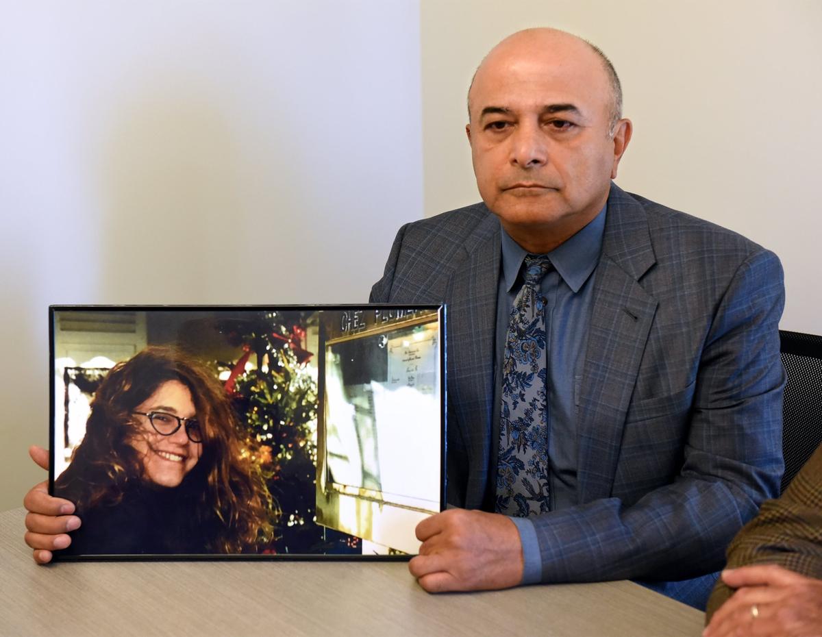Widower Hanibal Yadegar holds a picture of his wife, Evin Olsen Yadegar, on Monday morning, Sept. 17, 2018, at the conclusion of a court hearing for Stanislaus County sheriff’s Deputy Justin Wall in San Joaquin Superior Court. The deputy is accused of voluntary manslaughter in the shooting death of the Modesto woman during a pursuit in Ripon, Calif.