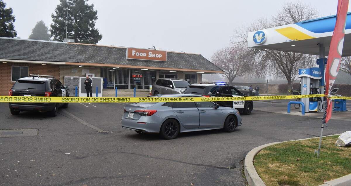 Police investigate an incident in which two people were shot at the Valero gas station on Prescott Road in Modesto, Calif., on the morning of Dec. 24, 2023.