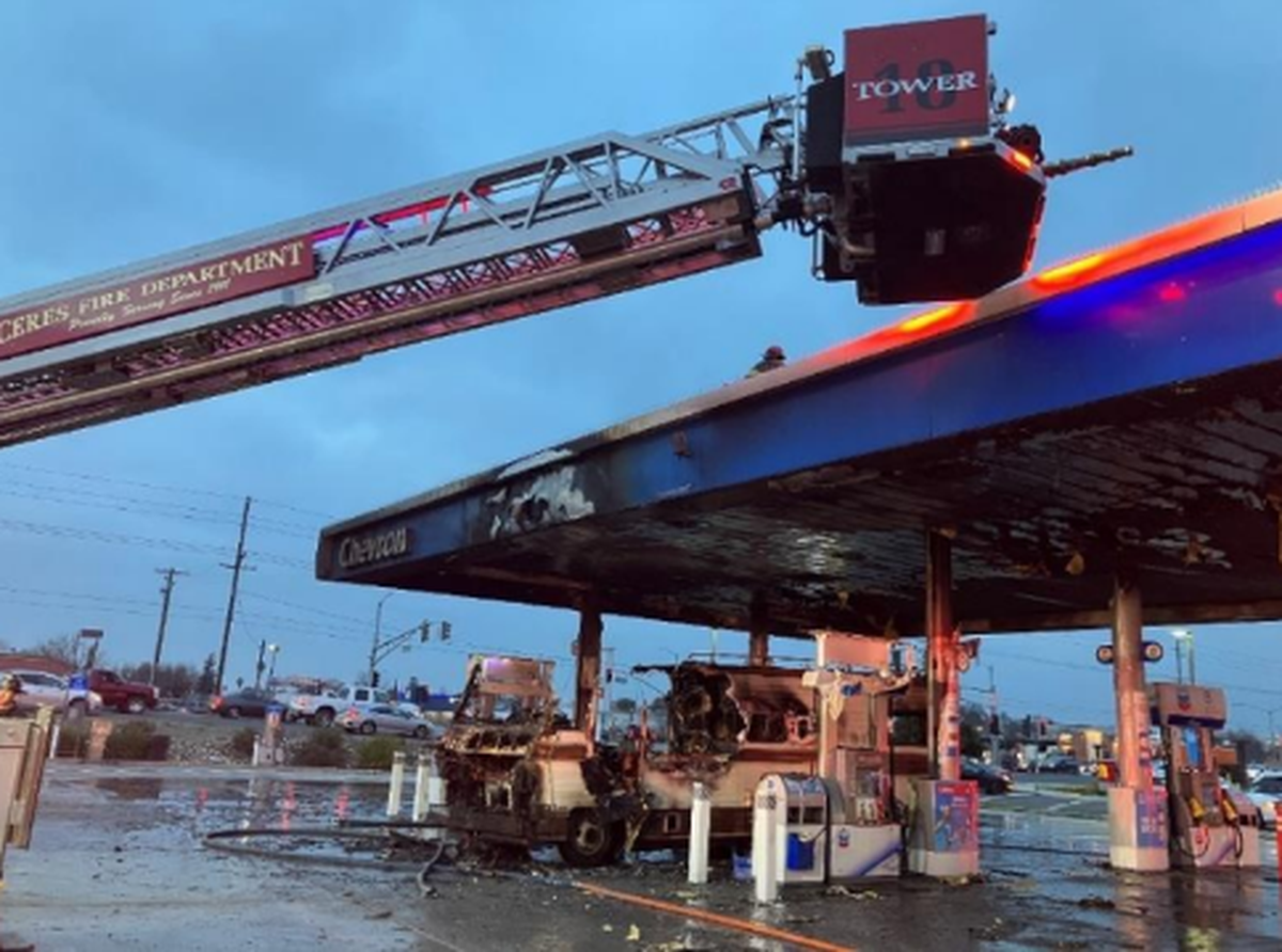 Firefighters from the Modesto Fire Department cleanup the aftermath of a fully-involved vehicle fire at a Chevron gas station on the 1500 block of Herndon Road in south Modesto on Tuesday, Jan. 16, 2024.