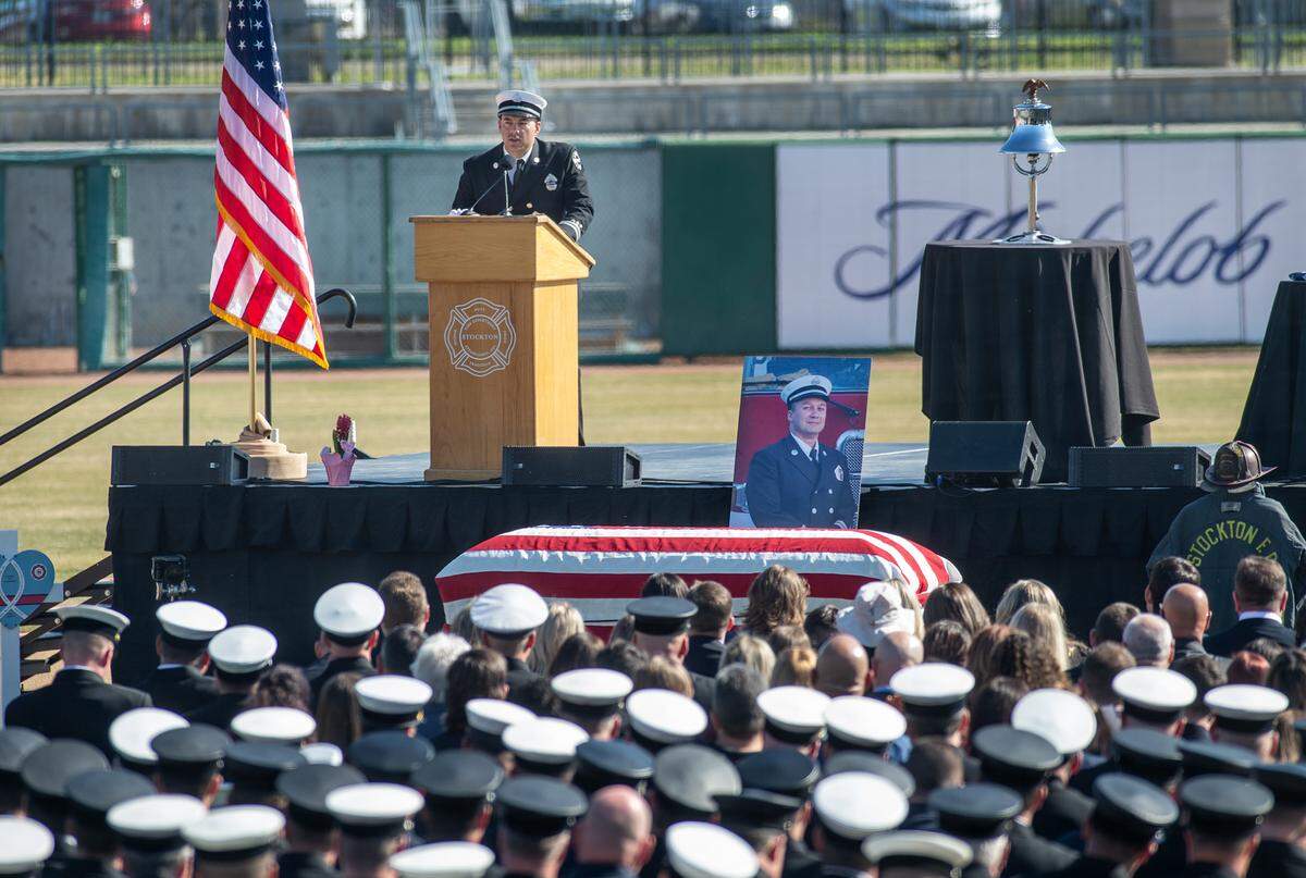 Fire Capt. Ryan Hoskinson speaks of his friend and fellow firefighter Max Fortuna during the memorial service for the fallen Stockton fire captain at the Banner Island Ballpark in Stockton, Calif., on Tuesday, Feb. 8, 2022.