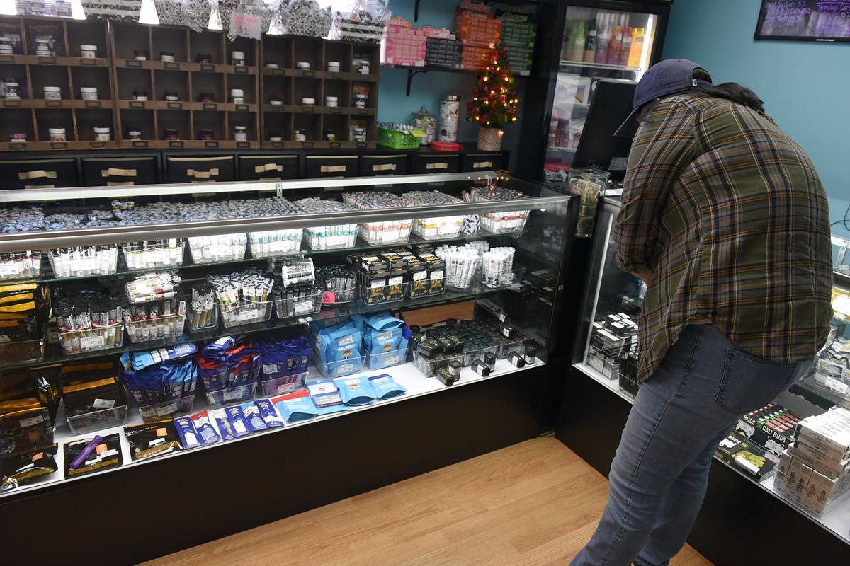 A customer chooses product on Friday afternoon December 7, 2018 at The People’s Remedy marijuana dispensary in Modesto, Calif.