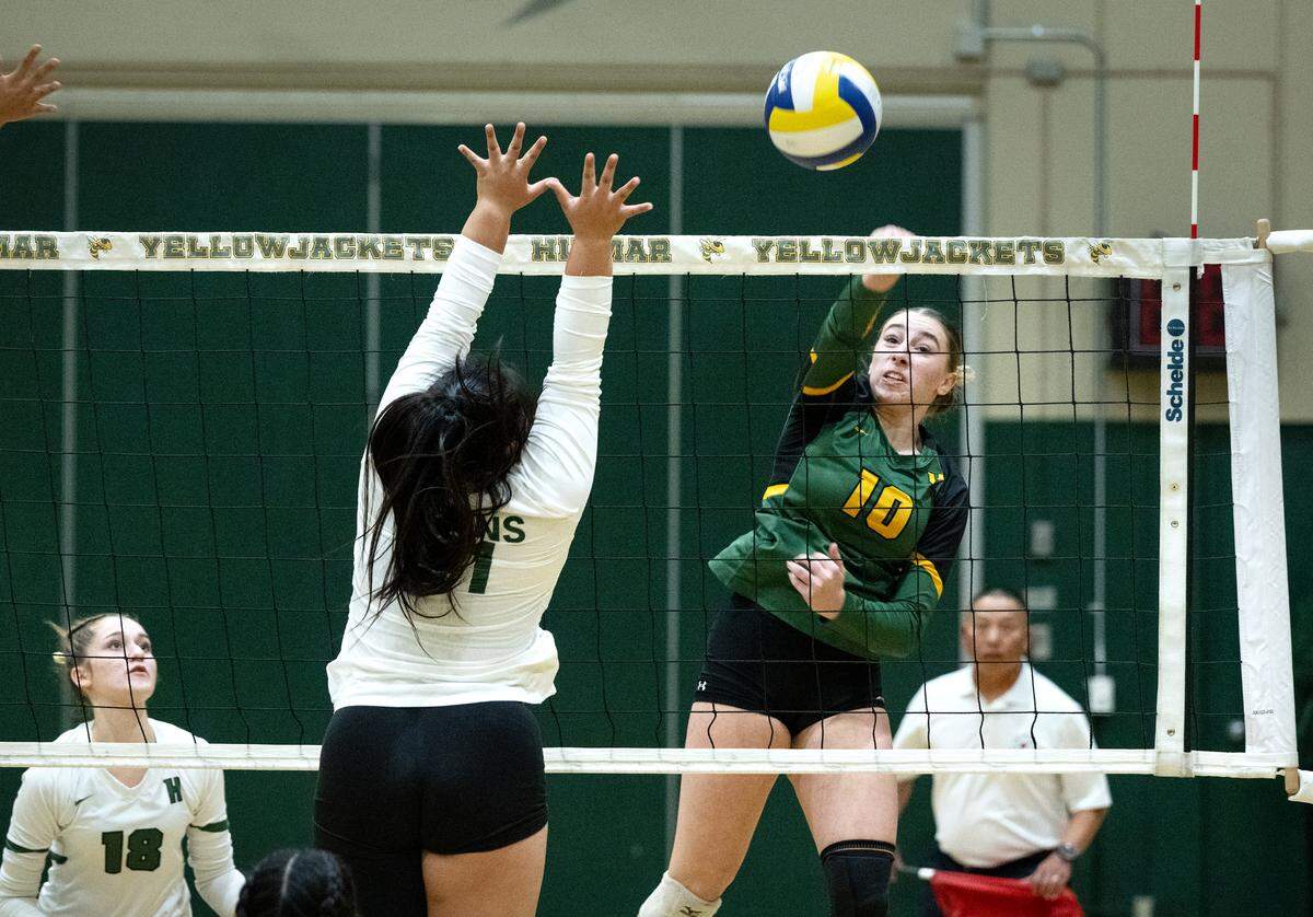 Hilmar’s Finley Rosa hits the ball down the line past St. Patrick-St. Vincent defender Danica Pagtakhan during the CIF Northern California Division IV volleyball championship match at Hilmar High School in Hilmar, Tuesday, Nov. 19, 2024.