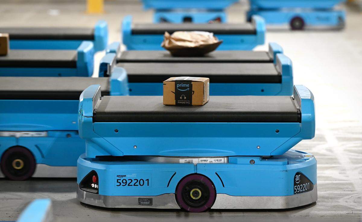 Pegasus robots move packages at the Amazon robotic sort center in Tracy, Calif., Thursday, Nov. 10, 2022. The robots use QR codes to complete their route.