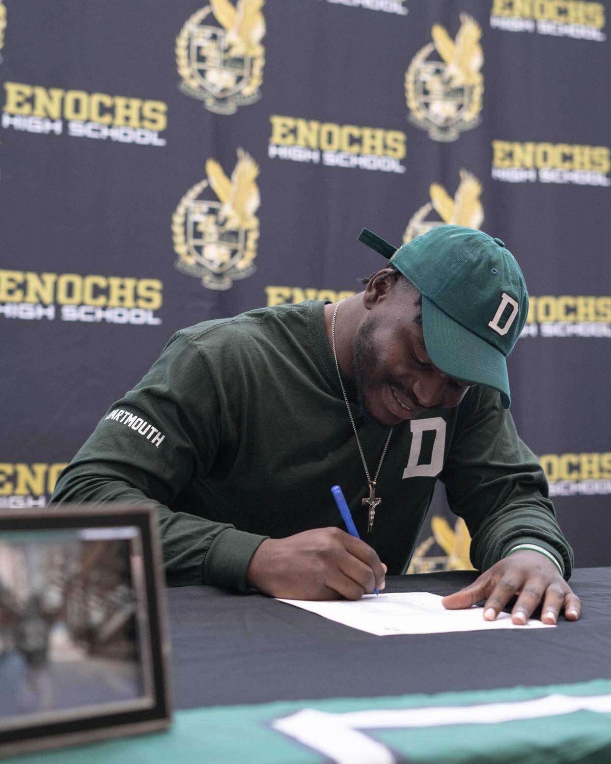 Enochs High School linebacker Yomi Babalola signs his letter of intent to play football at Dartmouth University at Enochs High School on Thursday, March 31, 2022.