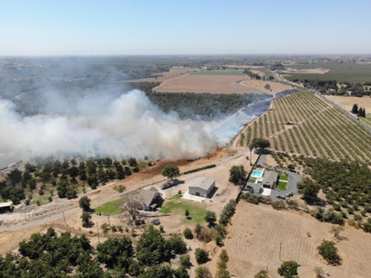 Firefighters battle a structure and brush fire on River Road in Oakdale that eventually burned through nearly 10 acres before it was contained on Aug. 29, 2025.