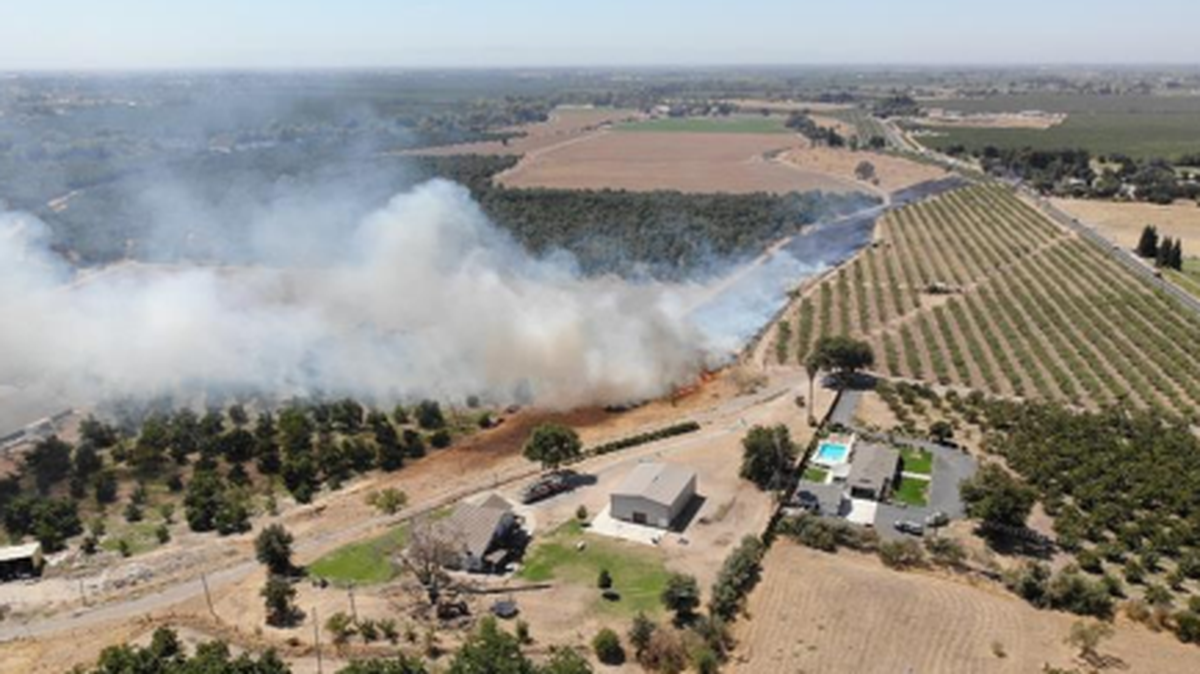 Firefighters battle a structure and brush fire on River Road in Oakdale that eventually burned through nearly 10 acres before it was contained on Aug. 29, 2025.