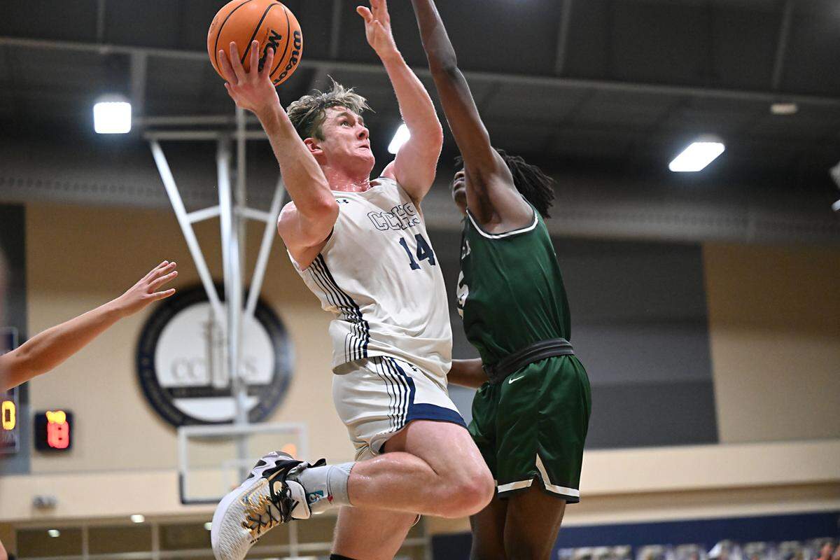 Central Catholic’s Wesley Payne drives to the hoop for a score as Manteca’s Santiago Sanders defends during the Valley Oak League game at Central Catholic High School in Modesto, Calif., Wednesday, Feb. 7, 2024.