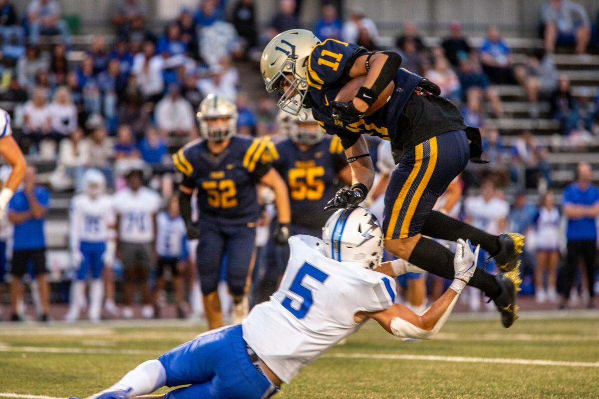 Turlock’s Landyn Fitzgerald, 11, tries to go over Derek Keeley, 5, of Rocklin during the first half of their game at Turlock High Aug. 23, 2024.