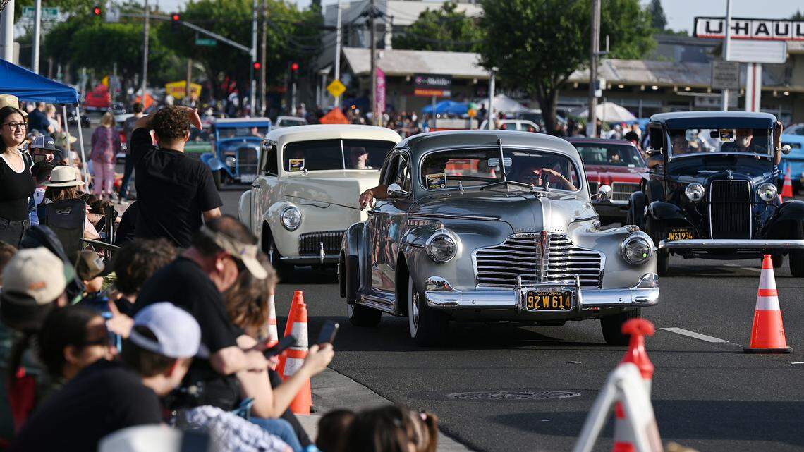 Classic car owners cruise down McHenry Avenue during the Graffiti Parade in Modesto, Calif., Friday, June 9, 2023.