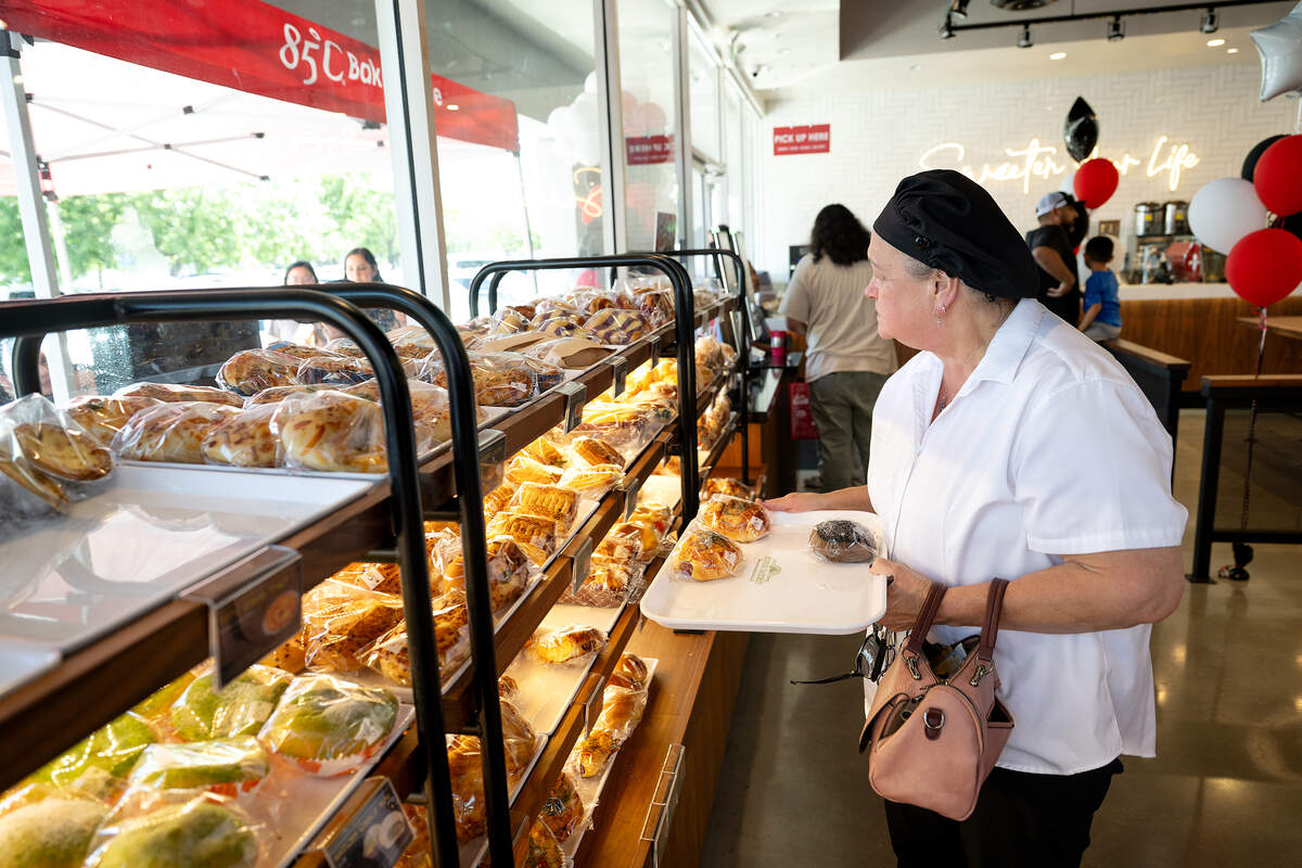 Bambi Nowlin selects some baked goods during the grand opening of 85°C Bakery Cafe in Modesto Friday, June 12, 2026.