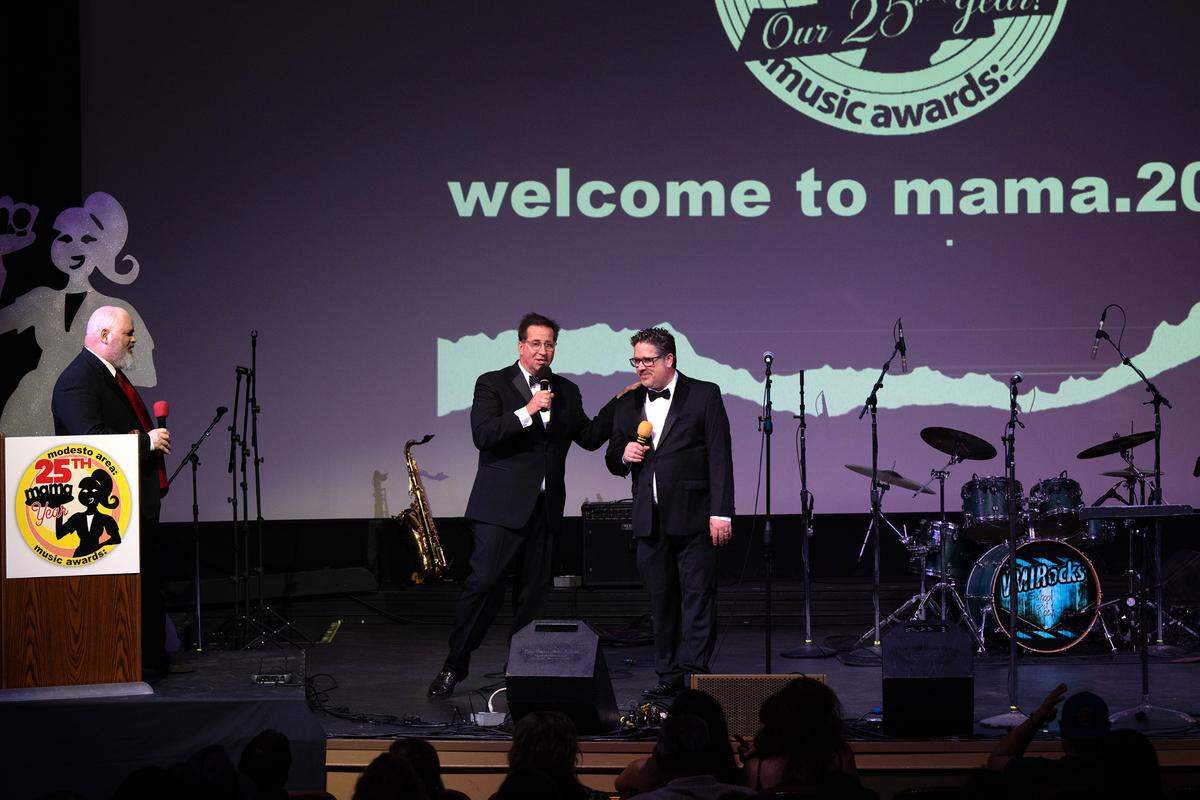 MAMA’s co-founders and hosts Chris Murphy, middle, and Chris Ricci, right, talk about the history of the awards show during the 25th annual Modesto Area Music Association’s MAMA awards at the State Theatre in Modesto, Tuesday, Oct. 15, 2024.