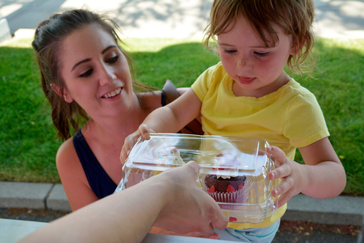 Shelby White and her 3-year-old daughter Brooklyn White order cupcakes at the new Cupcake Boutique food trailer in Modesto, Calif. July 30, 2021.