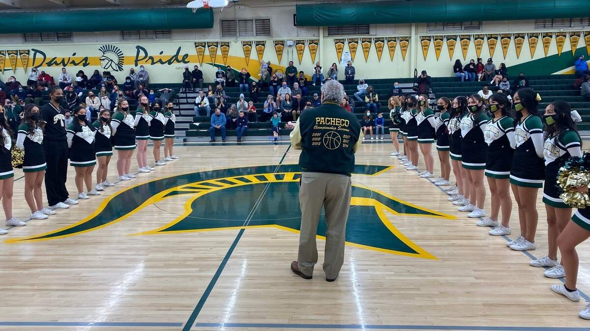Legendary basketball coach Dan Pacheco stands at center court at the Davis High School dedication ceremony on Dec. 17, 2021.