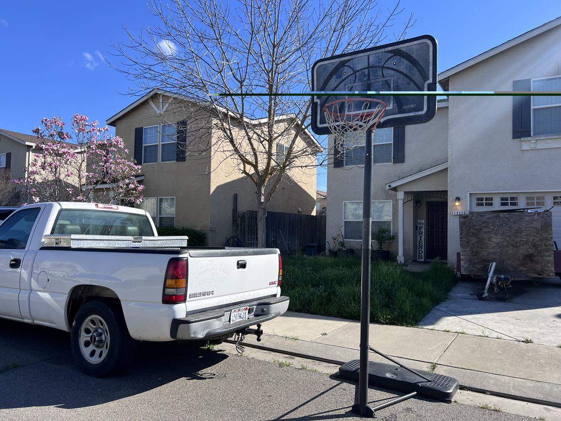 A basketball hoop left on street in Merced, California.