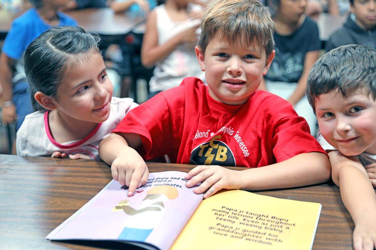 Students at Walter White Elementary School show a copy of Manrup ‘Rupy’ Khatkar’s children’s book, ‘Rupy and Papa ji: Soulmates for Life.’