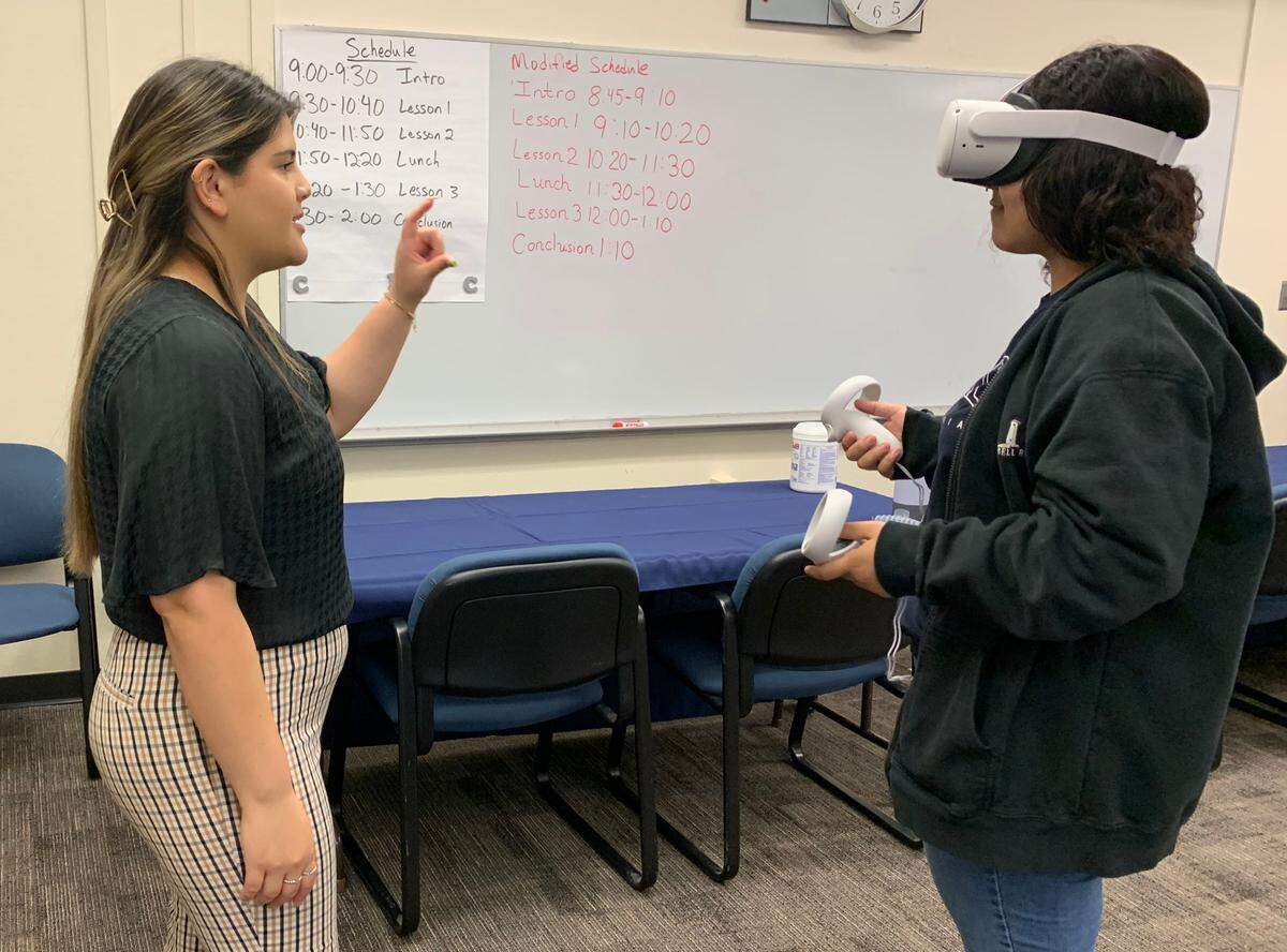 Facilitator Abby Solis walks a student through using a virtual reality headset March 22 at the Career Inspiration Center run by the Stanislaus County Office of Education.